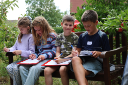 St Mark's Chiuldren on a bench in the garden
