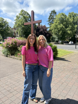 Two people with the cross outside at St Mark's Church